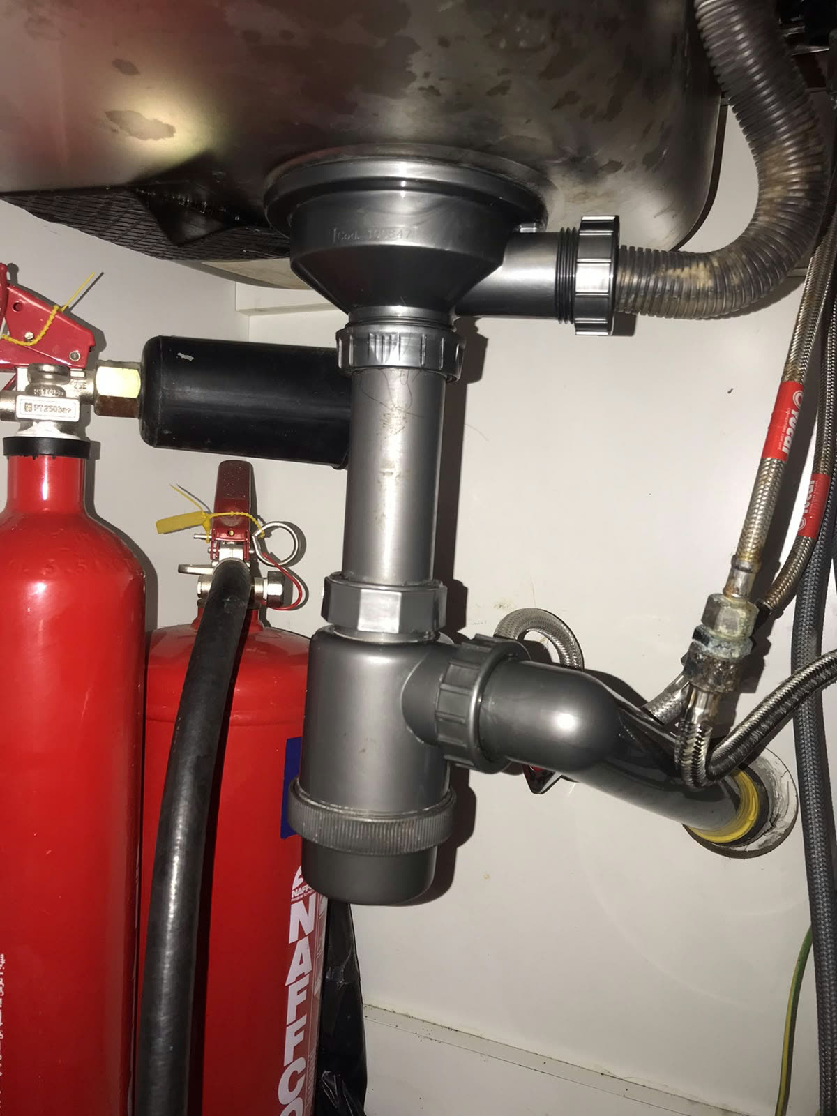 Plumbing after: Trap, valves and hoses replaced and tested.