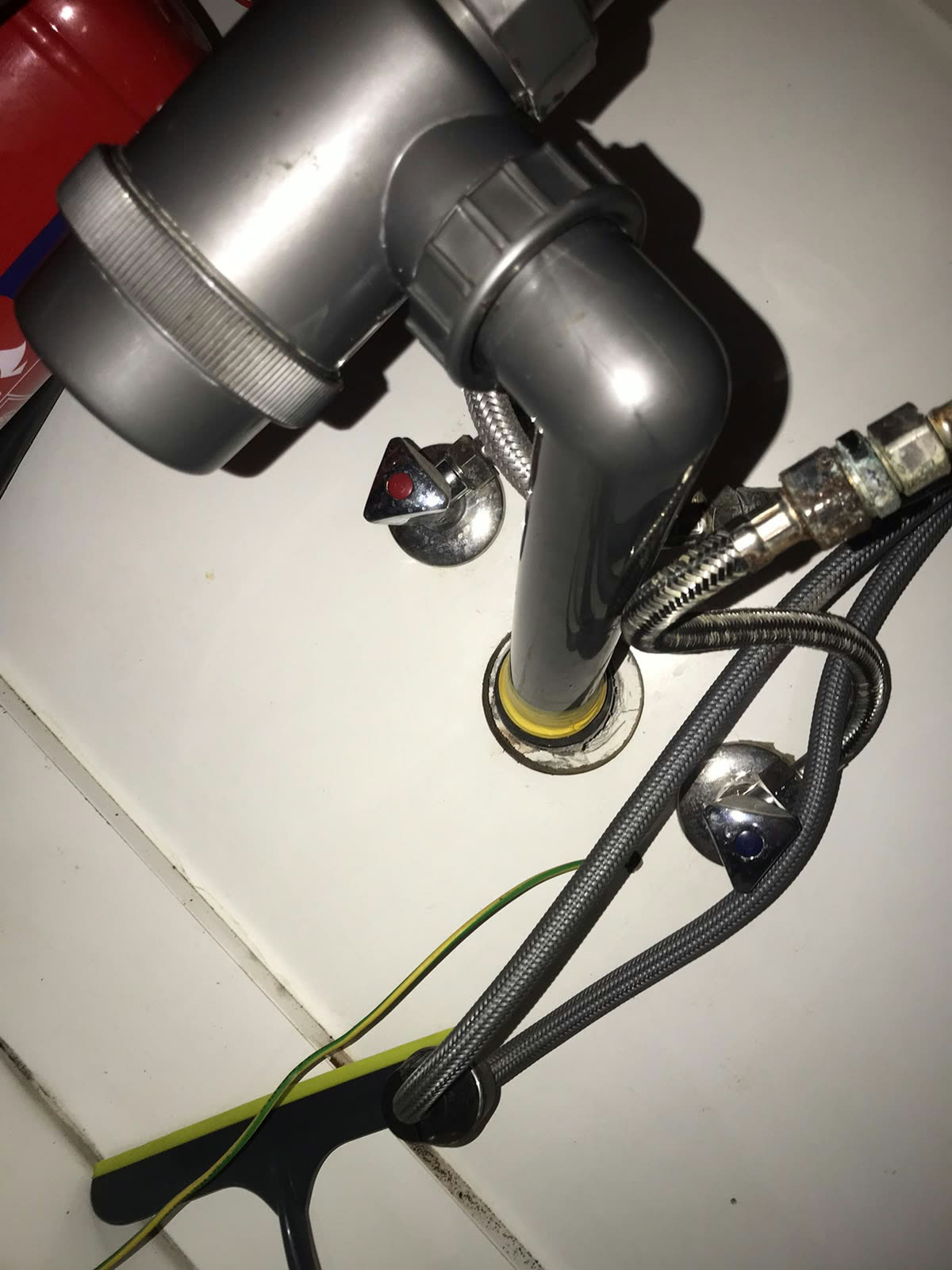 Plumbing before: Leaking under-sink trap.